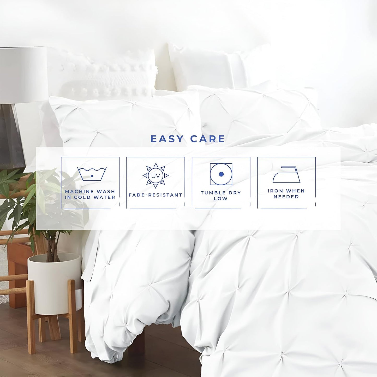 White bedding pinch pleated duvet cover set 3Pcs with care instructions on a bed in a room with a lamp and plant.