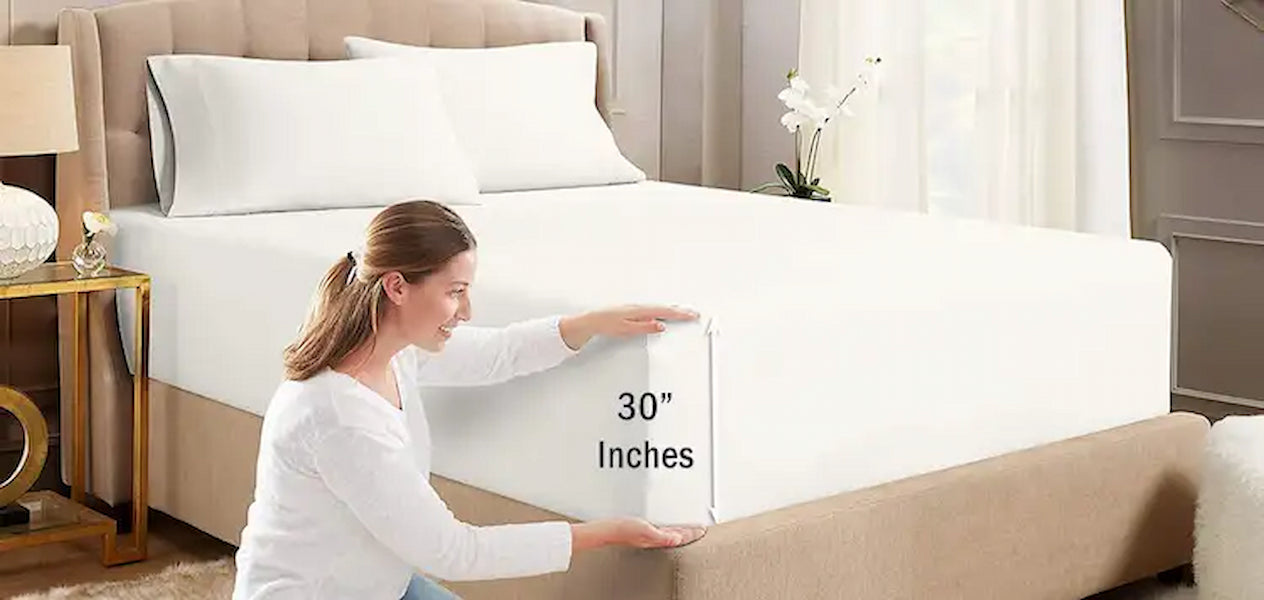 Woman holding a 30-inch mattress topper in a bedroom setting.