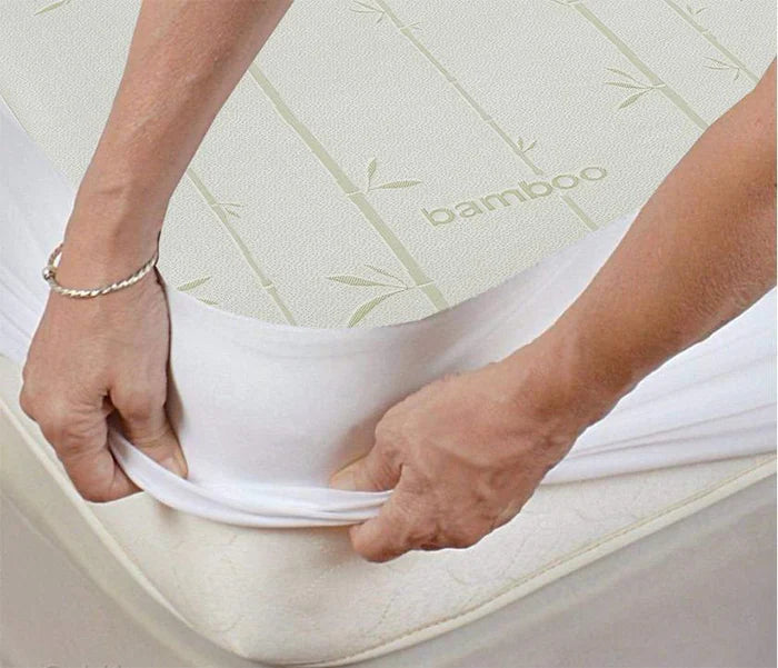 Waterproof antibacterial and hypoallergenic bamboo mattress protector covering a bed